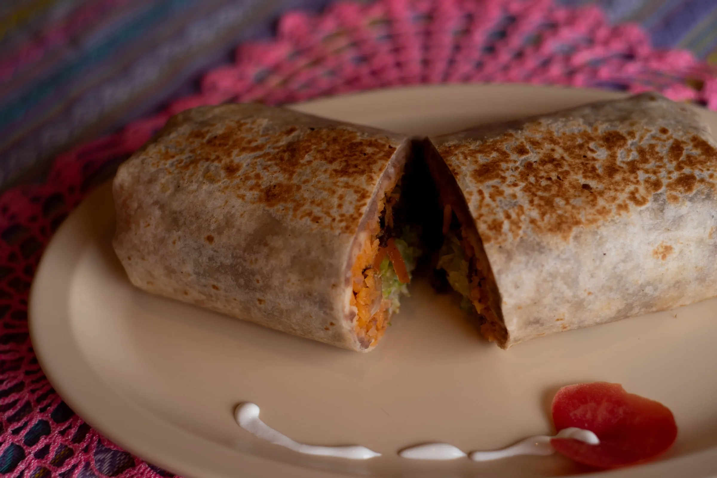 A burrito cut in half on a plate