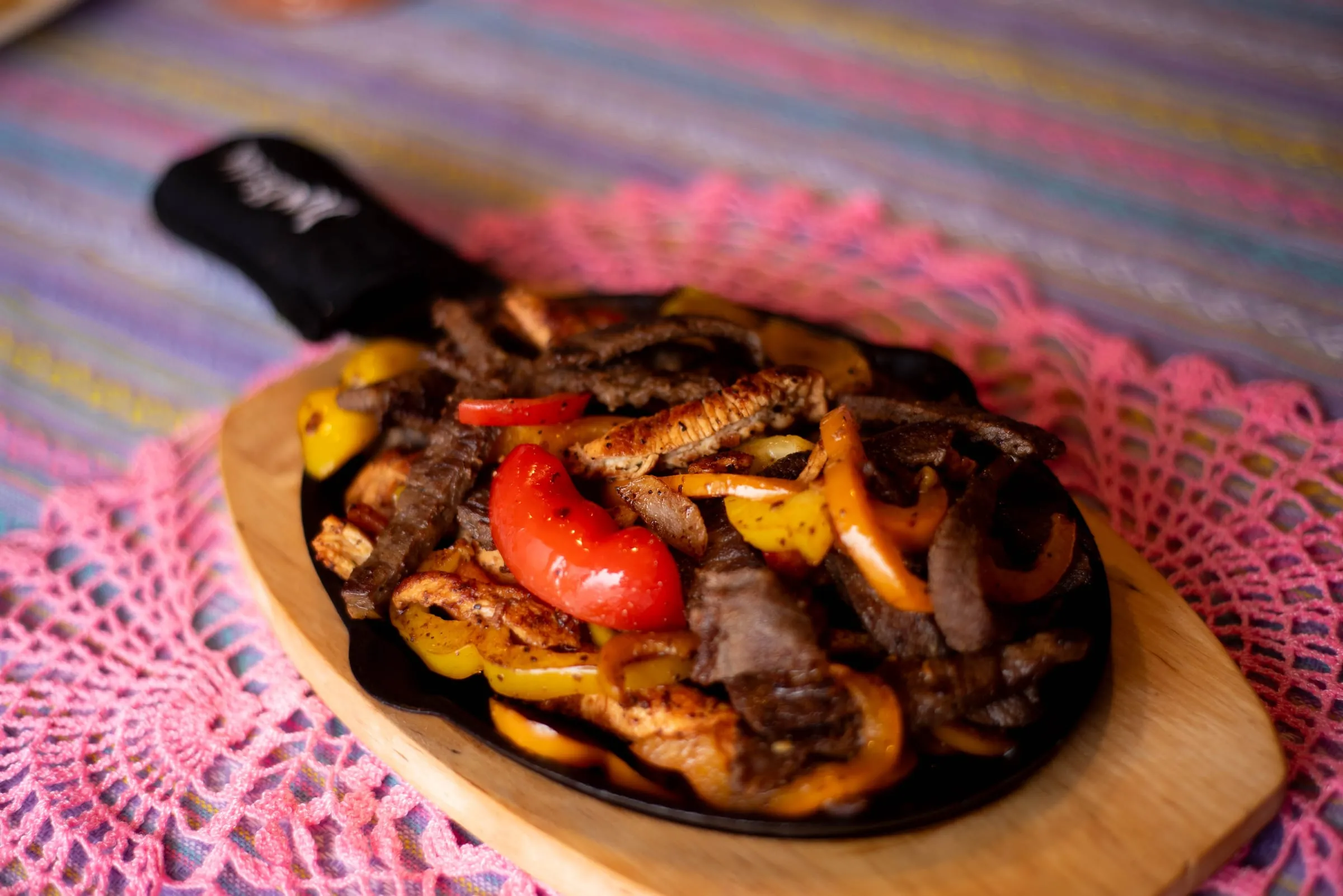 Fajitas with peppers on a hot skillet