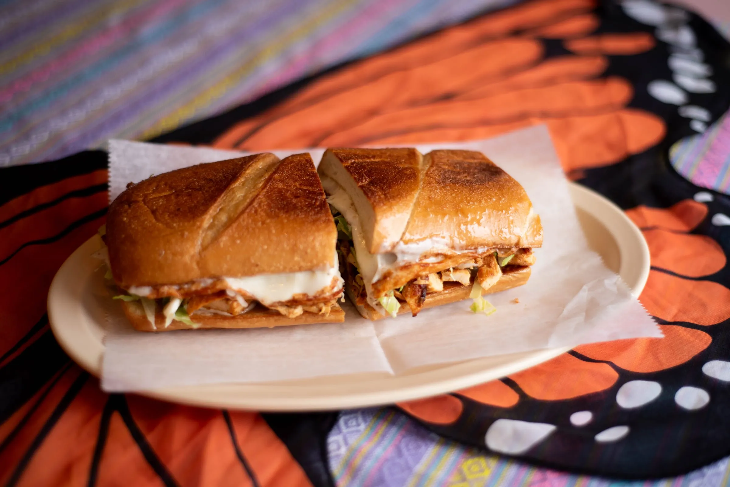 A toasted torta cut in half on a plate